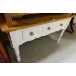 A painted pine dresser base, the pine top above white painted base with three drawers on tapered