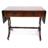 A mahogany and ebony strung sofa table in Regency style, with a reeded edge above two frieze drawers