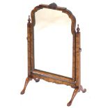 A walnut dressing mirror, in mid 18thC style, with arched shaped plate on square tapering end suppor