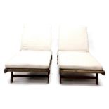 A pair of hardwood adjustable garden loungers, each with a padded cushion, 196cm long.
