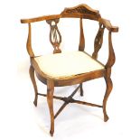 An Edwardian beech corner chair, with two pierced lyre shaped splats, a padded seat on cabriole legs