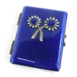 An early 20thC blue enamel and silver plated compact, with paste stone set double flower decoration