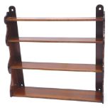 A Victorian mahogany graduated wall shelf, on shaped end supports, 84cm wide.