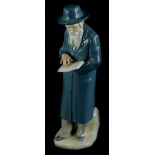 A Nao porcelain figure, of a Jewish gentleman holding a book, on a shaped base, paper label to under