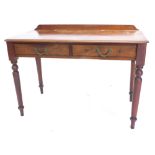 A mahogany table, with a raised back above two frieze drawers, on turned tapering legs, 70cm high, 1