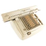 A Lagomarsino Numeria adding machine, in beige metal case, 43cm wide.