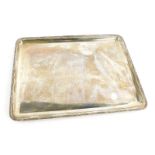 A George VI silver tray, of rectangular form, the border decorated with leaves etc., London 1919, 1
