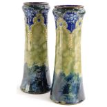 A pair of Royal Doulton stoneware vases, each with raised and incised decoration of flowers, scrolls