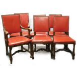 A set of six oak dining chairs, each with a red leather padded back and seat, with brass studded bor