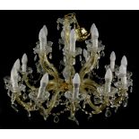A cut glass chandelier, with eighteen shaped arms, 74cm wide.