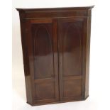 A 19thC mahogany and chequer banded hanging corner cabinet, with a moulded cornice above two doors,