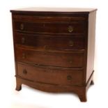 A mahogany bowfronted chest of drawers, the top with a reeded edge above a brushing slide and four g