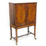 A mahogany drinks cabinet, the top with a boxwood strung and crossbanded border, above two doors, ea