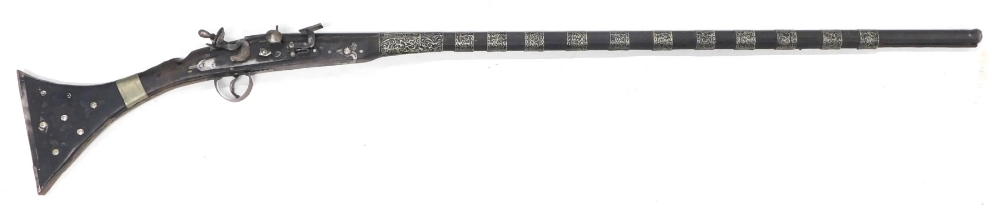 A Middle Eastern rifle, with silver coloured metal bands, etc., 141cm long.