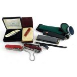 A collection of pen knives, etc., to include a Swiss Army, a Zippo, etc.