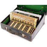 A Tandoral piano accordion, with marble effect decoration, in a fitted case.