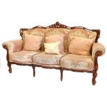 A continental beech three seater sofa, in the French style, upholstered in pink, cream and grey fabr