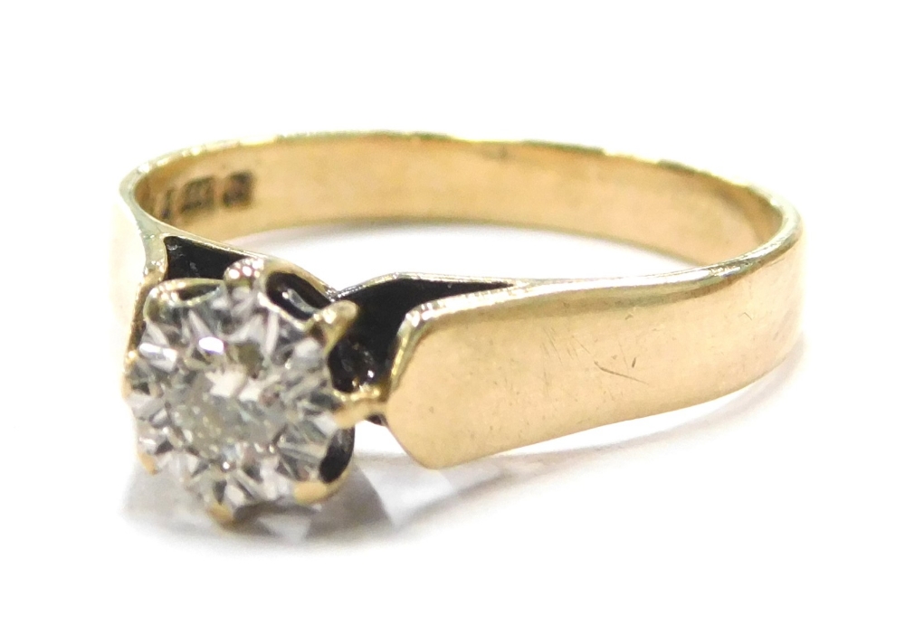 A 9ct gold solitaire ring, set with imitation tiny diamond, in a white gold setting, raised shoulder