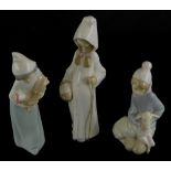 A collection of three Lladro figures, to include a young girl with a walking stick, a child with a c