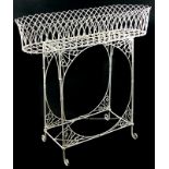 A 19thC wire work jardiniere or plant stand, decorated with arches on end supports with brackets and