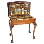An early to mid 20thC canteen of cutlery, the mahogany bow fronted case, with a gadrooned border to