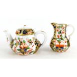 A 19thC Stevenson and Hancock Derby porcelain Imari pattern miniature teapot, and a small jug. (2)