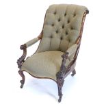 A Victorian rosewood armchair, with scroll carved showframe, buttoned padded back, arm rests and sea