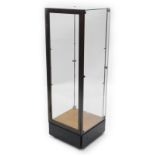 A Rowlings and Co shop bronzed metal shop display cabinet, with chrome plated fittings, on a black g
