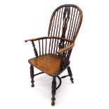 A mid 19thC yew, ash and elm Windsor armchair, with a pierced splat, solid dish seat, on turned legs