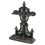 A Victorian cast iron umbrella stand, with pierced decoration to the raised back and shaped beaded d