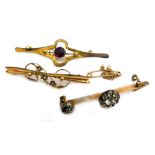 Three bar brooches, comprising a Victorian 9ct bar brooch, set with three flowers, each with seed pe