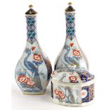 A pair of Vista Elegre porcelain vases, each decorated in the oriental style with birds, flowers, le
