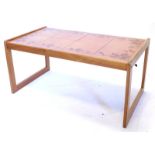 A teak rectangular coffee table, with a brown glaze tile top, 84cm wide.