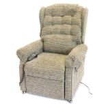 An electric rise and fall armchair, upholstered in patterned grey fabric.