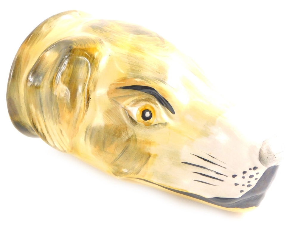 A Staffordshire type porcelain stirrup cup, model in the form of a greyhound head, 13cm high.
