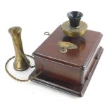 An early 20thC vintage telephone, with brass and black Bakelite mouth piece, brass handset and mahog