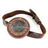 A WWII US Army Airborne wrist compass, in brown Bakelite with leather strap.