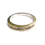 An 18ct white gold half hoop eternity ring, set with tiny diamonds in tension setting, ring size M½,