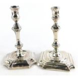 A late Victorian taper candlestick, in Georgian style with a knopped column issuing from a shaped sq