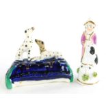 A 19thC Staffordshire porcelain miniature inkwell, modelled with Dalmatians, (AF), 7cm wide, and a s