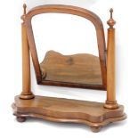 A Victorian mahogany dressing table mirror, with an arched plate on tapering cylindrical supports an