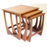 A nest of three G-plan teak tables, each on end supports, the largest 51cm wide.