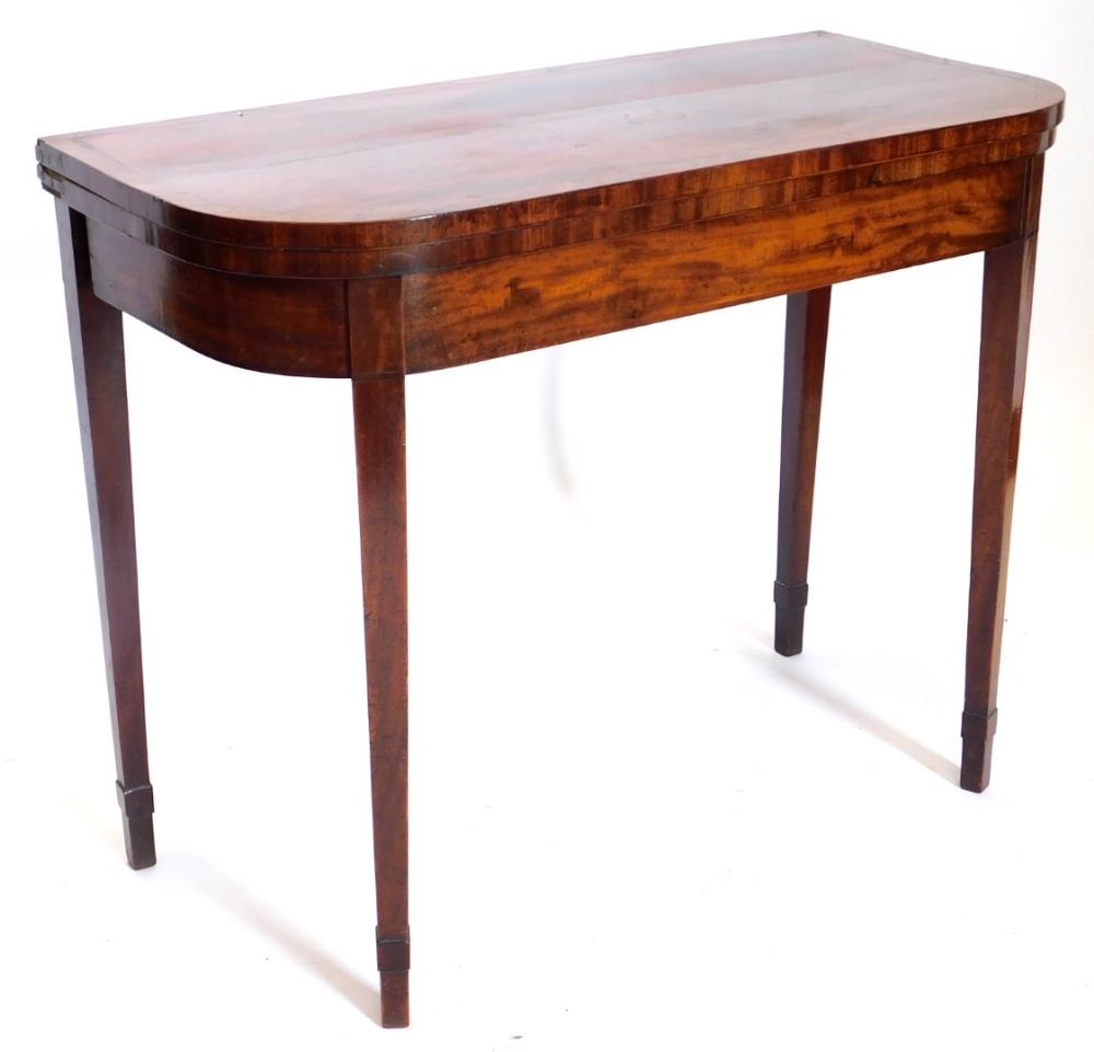 An early 19thC mahogany D shaped card table, with a boxwood strung and crossbanded border, on square