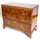 A mid 18thC walnut chest of drawers, the quarter veneered top with a central oval and feather banded