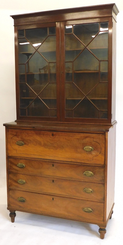 An early 19thC mahogany secretaire bookcase, the top with a moulded corner above two astragal glazed