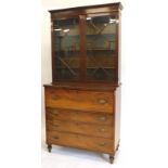 An early 19thC mahogany secretaire bookcase, the top with a moulded corner above two astragal glazed