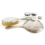 A collection of silver dressing table items, to include a silver framed mirror, marks rubbed, a silv