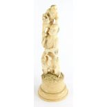 A late 19thC Japanese ivory Okimono, carved in the form of a gentleman with a young child on his sho