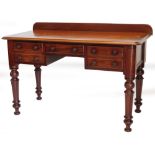 A 19thC mahogany small sideboard or desk, the top with a raised back and a moulded edge, above five