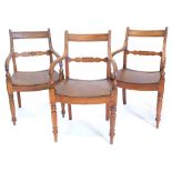 A pair of early 19thC elm country made open armchairs, each with a shaped back support with central